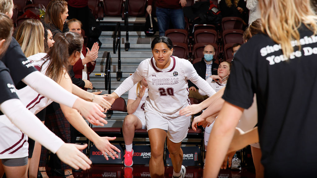 Basketball player high-fiving her teammates