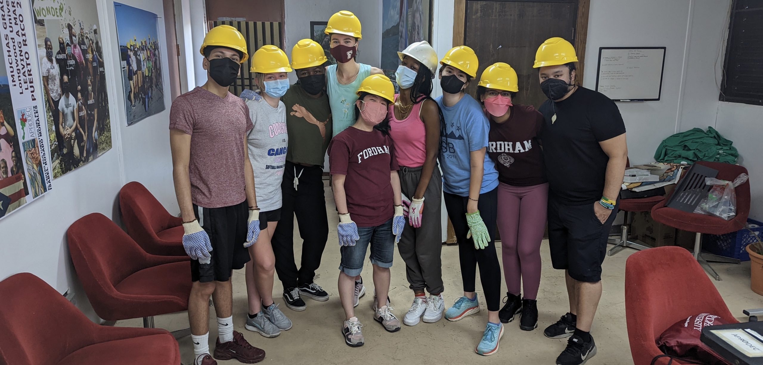 Students working in Ceiba, Puerto Rico with APRODEC, wearing hardhats